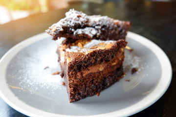 brownies cake on the table / piece of chocolate cake cocoa with nut and icing sugar