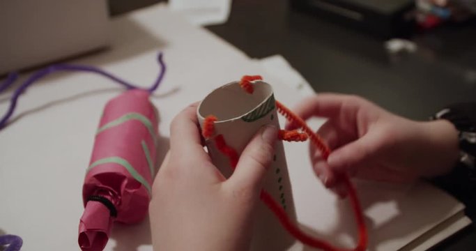 Little girl crafting homemade Christmas ornaments for the Christmas tree. 4K.
