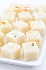 Indian Popular Sweet Food Khopara Pak or Coconut Burfi made up of Coconut, Milk And Sugar Isolated on White Background