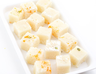 Indian Popular Sweet Food Khopara Pak or Coconut Burfi made up of Coconut, Milk And Sugar Isolated on White Background