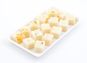 Indian Popular Sweet Food Khopara Pak or Coconut Burfi made up of Coconut, Milk And Sugar Isolated on White Background