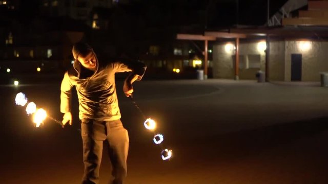 Gimbal shot of man spinning poi