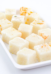 Indian Popular Sweet Food Khopara Pak or Coconut Burfi made up of Coconut, Milk And Sugar Isolated on White Background
