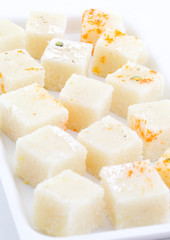 Indian Popular Sweet Food Khopara Pak or Coconut Burfi made up of Coconut, Milk And Sugar Isolated on White Background
