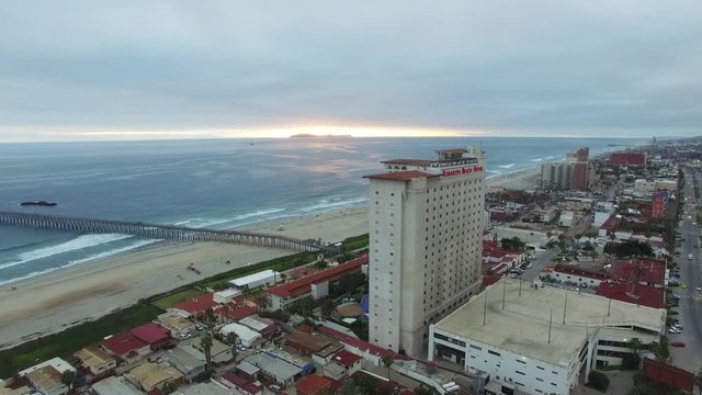 Aerial rotation around Rosarito Beach hotel with views out to sea & coast.