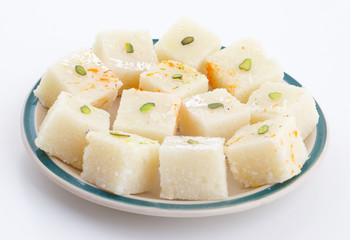 Indian Popular Sweet Food Khopara Pak or Coconut Burfi made up of Coconut, Milk And Sugar Isolated on White Background