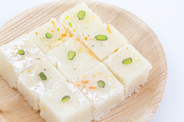 Indian Popular Sweet Food Khopara Pak or Coconut Burfi made up of Coconut, Milk And Sugar Isolated on White Background