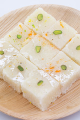 Indian Popular Sweet Food Khopara Pak or Coconut Burfi made up of Coconut, Milk And Sugar Isolated on White Background