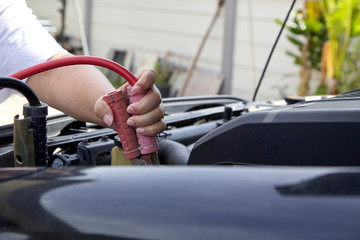 Hand of woman checking engine of car Maintenance