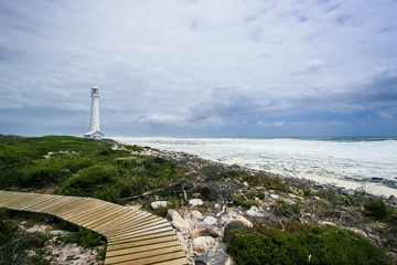 Lighthouse on a rugged coastline during the daytime