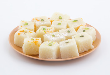 Indian Popular Sweet Food Khopara Pak or Coconut Burfi made up of Coconut, Milk And Sugar Isolated on White Background