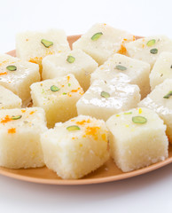 Indian Popular Sweet Food Khopara Pak or Coconut Burfi made up of Coconut, Milk And Sugar Isolated on White Background