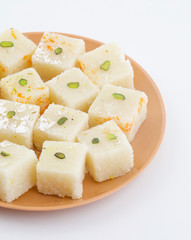 Indian Popular Sweet Food Khopara Pak or Coconut Burfi made up of Coconut, Milk And Sugar Isolated on White Background