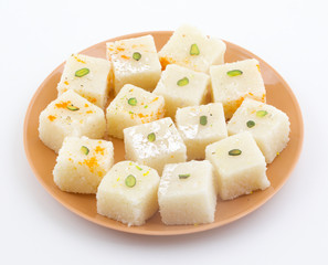 Indian Popular Sweet Food Khopara Pak or Coconut Burfi made up of Coconut, Milk And Sugar Isolated on White Background