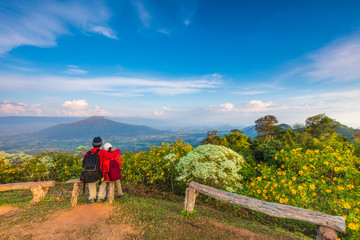 Obraz premium The lovers in red jacket touring on the beautiful mountain.