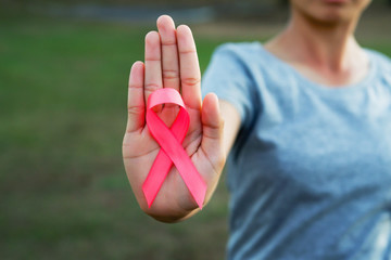 woman holding pink ribbon breast cancer awareness. concept healthcare