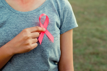 woman holding pink ribbon breast cancer awareness. concept healthcare