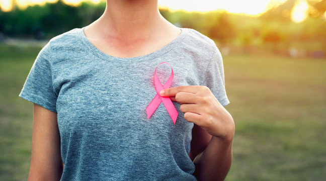 woman holding pink ribbon breast cancer awareness. concept healthcare