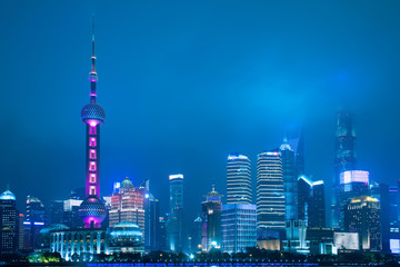 Shanghai city skyline business and travel landmark district urban view at night with coudy cityscape.