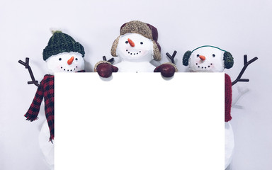 Snowman holding a blank banner 