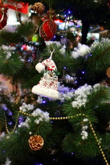 Christmas tree with toys and balls. Christmas tree with bright ornaments and lights. Festive happy new year decoration. Merry Christmas celebration concept. Winter holidays background.