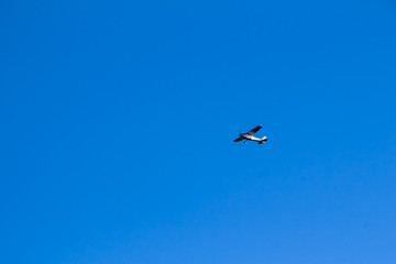 Free plane flying through blue clear sky in Austrian Zell am See