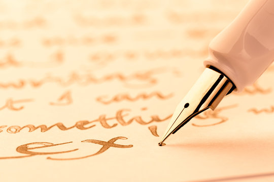 white fountain pen writing a letter