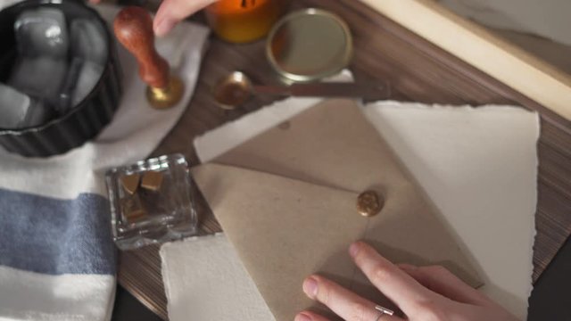 Stamping an Envelope with Gold Wax Seal
