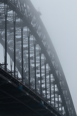 Close-up view of Sydney Harbour Bridge in a foggy morning.