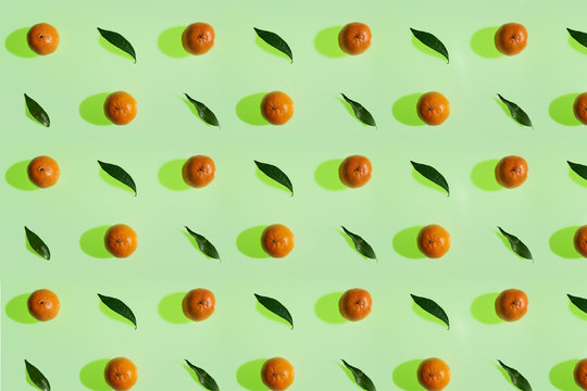 Tangerine pattern with leaves on a lime color background in high resolution