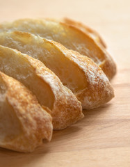 Sliced bread on a wooden table.