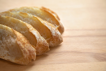 Sliced bread on a wooden table.