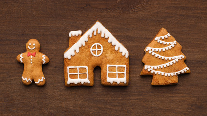 Sweet Christmas gingerbread cookies on wooden background
