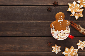 Gingerbread man bathing in cup of hot chocolate