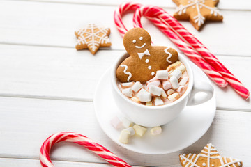 New Year gingerbread in cup of cocoa on white background