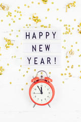 New Year composition alarm clock golden confetti