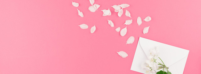 Flat lay of white letter mock up with petals