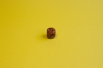 Dice on a yellow background. The concept of the game.