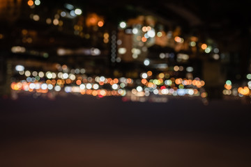 Fototapeta na wymiar blurred buildings with bright bokeh lights at night