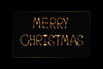 close up view of merry christmas light lettering on black backdrop
