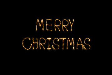 close up view of merry christmas light lettering on black backdrop