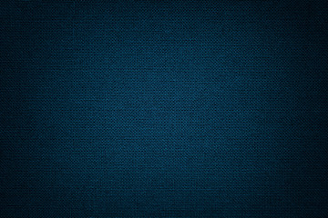 Dark blue background from a textile material. Fabric with natural texture. Backdrop.