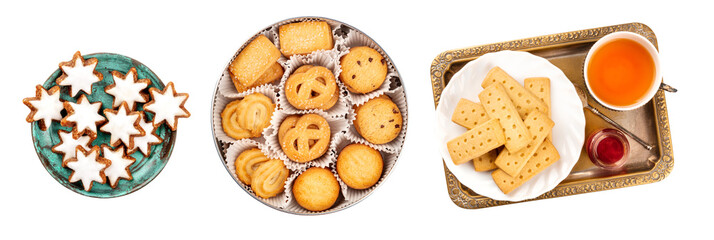 A set of isolated Christmas biscuits. German Zimsterne, cinnamon star cookies, Danish butter cookies, and British shortbreads, shot from the top on a white background