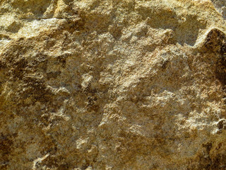 Deep textured brown stone background or blank wall