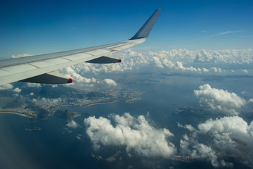 Wing of an airplane and clouds