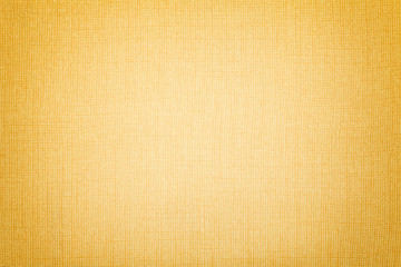 Golden background from a textile material. Fabric with natural texture. Backdrop.