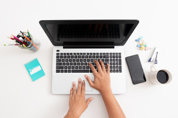 Business woman type on laptop computer on white office desk