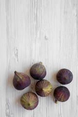 Fresh figs on a white wooden background, top view. Flat lay, overhead, from above. Copy space.