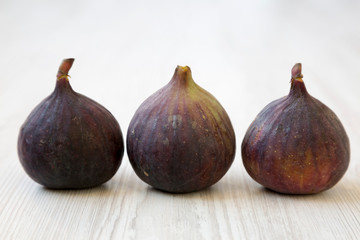 Fresh figs on a white wooden background, side view. Close-up.