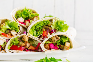 Chicken burrito. Healthy lunch.  Mexican street food fajita tortilla wraps with grilled  chicken fillet and fresh vegetables.